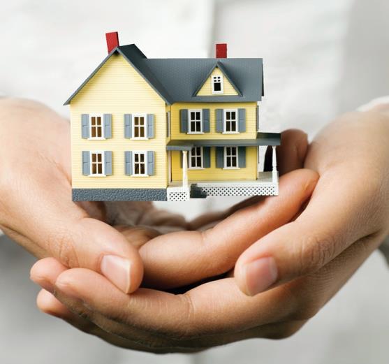 Hands holding a model house